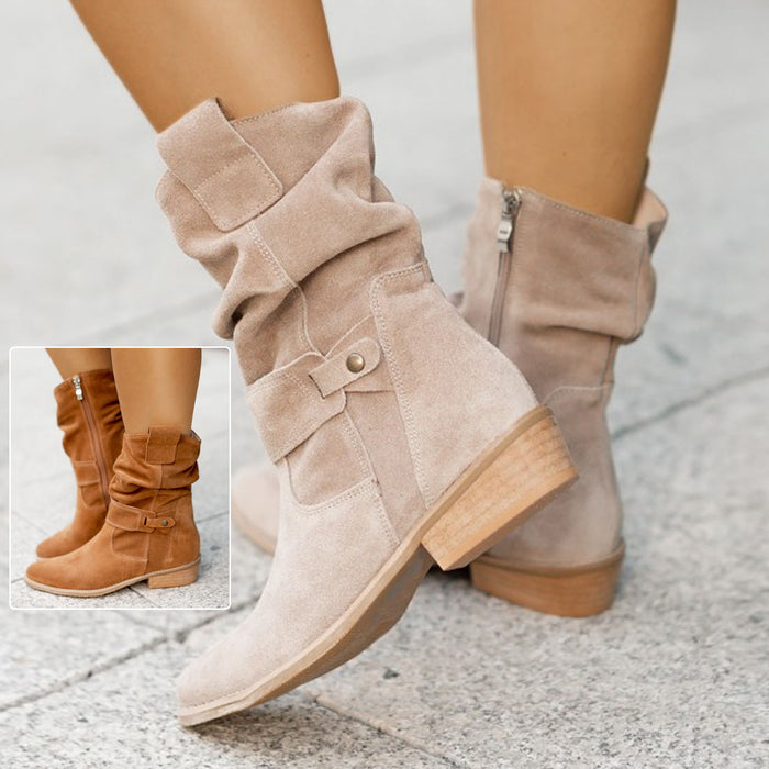 Black suede boot with pointed toe on marble floor