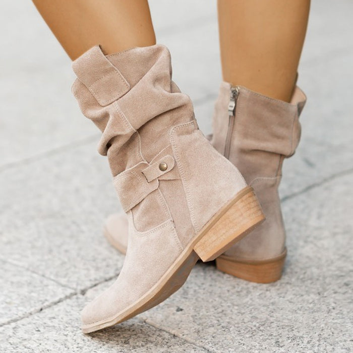 Brown suede boot lifestyle shot with autumn leaves