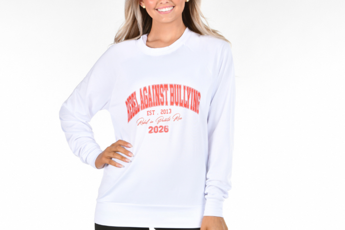 Woman wearing a white sweatshirt with red text and black leggings on a white background