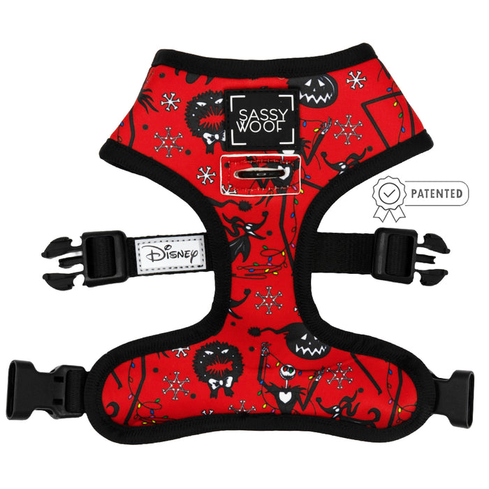 The Sassy Woof Reversible Harness - The Nightmare Before Christmas™ is a red, adjustable dog harness with black trim, Jack Skellington and snowflakes, black buckles, Disney and Sassy Woof logos, plus a patented side badge—perfect for growing pups.