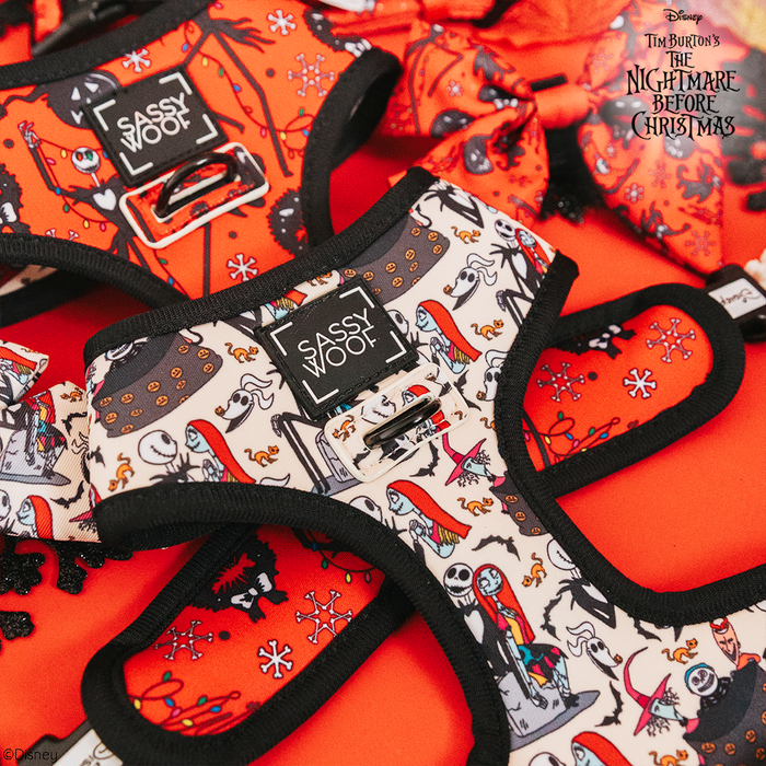 The Sassy Woof Reversible Harness - The Nightmare Before Christmas™ features bold designs in red, white, and black on bright orange, blending comfort and spooky style for your pup. Adjustable straps and the Sassy Woof logo complete the look.