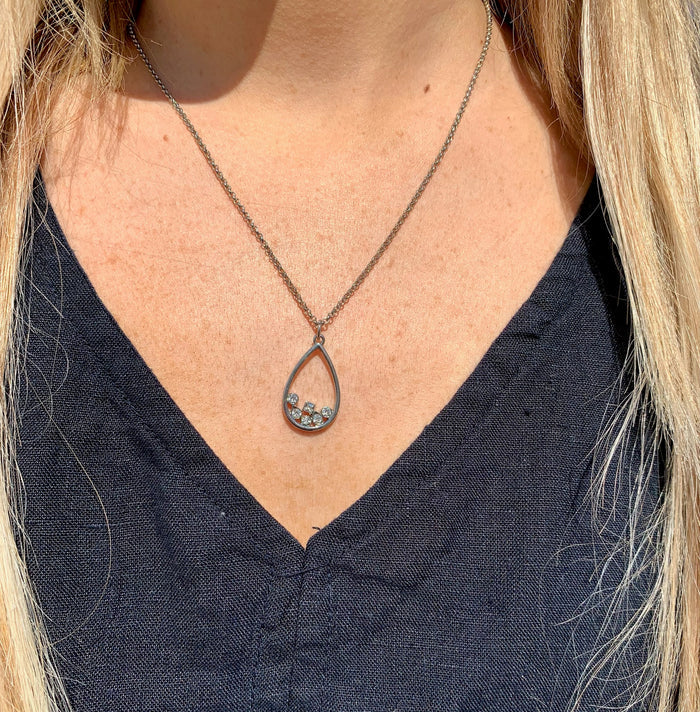 Rowan drop necklace silver on model.