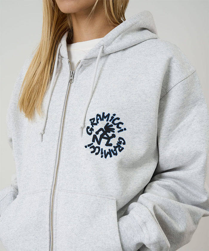 Model wearing heather ash Gramicci Running Man Zip Hooded Sweatshirt on a light-tone background.