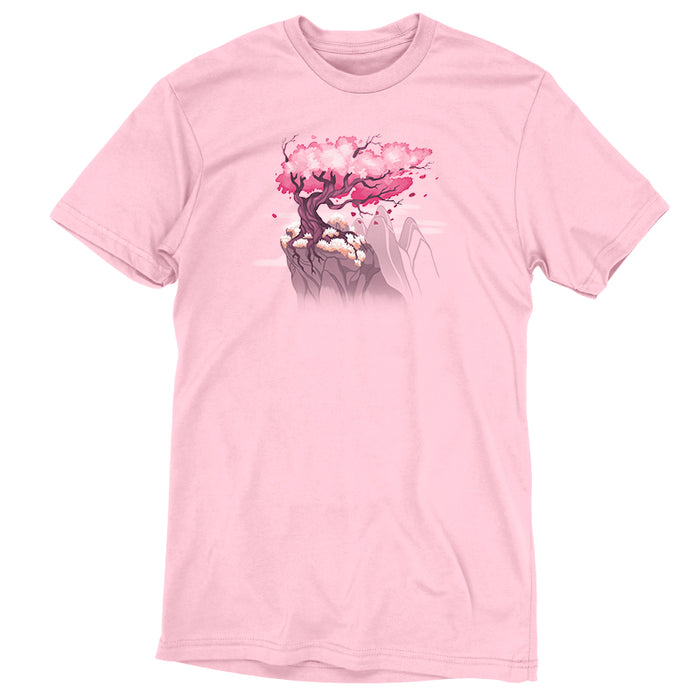 Premium Cotton T-shirt_TeeTurtle Sakura Tree light pink t-shirt featuring an illustration of a pink cherry blossom tree on a rocky cliff with mountains in the background. Blossoms and petals are being blown in the wind.
