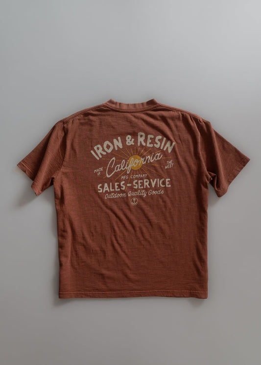 Brown T-shirt with "Iron & Resin California" and "Sales-Service" text, emphasizing outdoor quality goods.