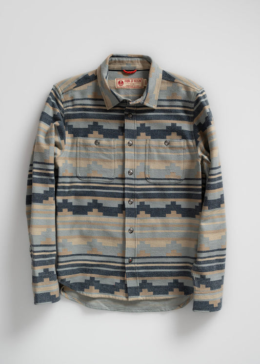 Patterned flannel shirt with geometric design, buttoned front, and two chest pockets, labeled "Iron & Resin" on the collar.