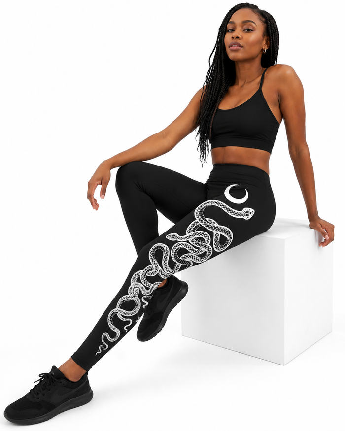 Ankle-length snake print leggings with white lunar snake art running down one leg for yoga, Pilates, workouts and streetwear.