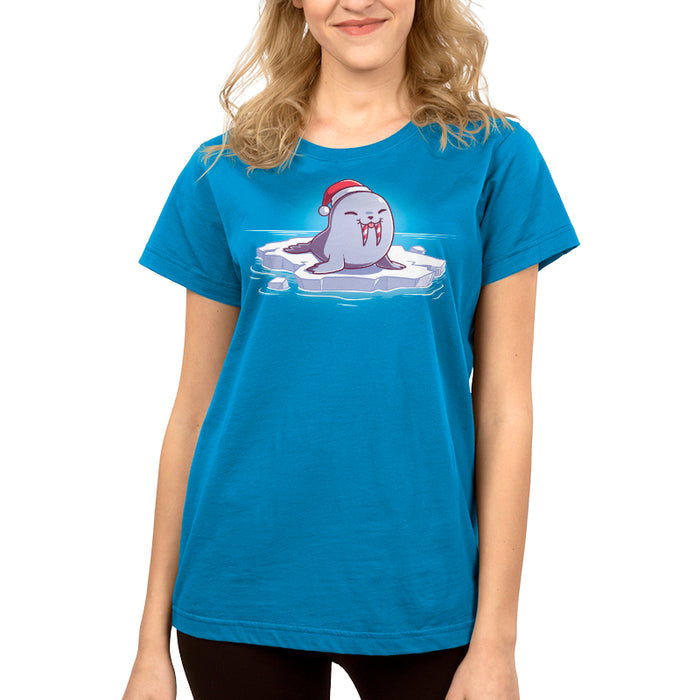 Premium Cotton T-shirt_TeeTurtle cobalt blue Sweet Tooth apparel featuring an illustration of a happy walrus sticking out it's tongue, wearing a Santa hat, and sitting on a floating ice. It's tusks are striped with red and white like candy canes.