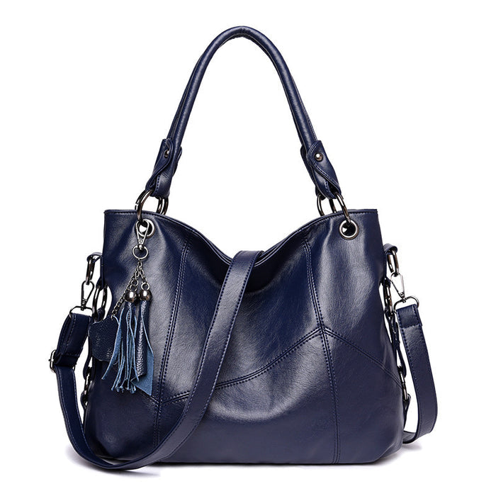 Women's tassel bucket crossbody bag interior zipper pockets phone slot layout