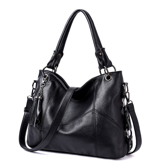 Close-up PU leather texture and stitching quality tassel bucket bag wine red