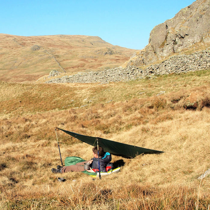 Terra Nova Adventure tarp 1 used by a backpacker outdoors as a sleeping shelter on the moors