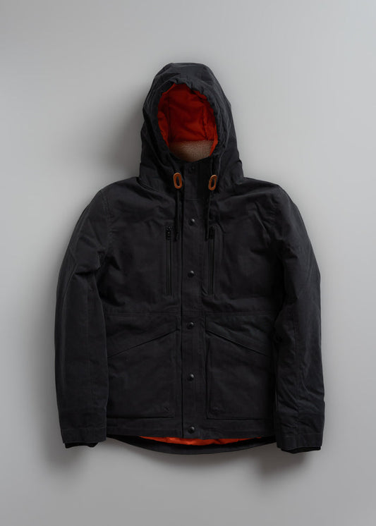 Black hooded jacket with orange lining, front view on gray background. Features multiple pockets and button details.