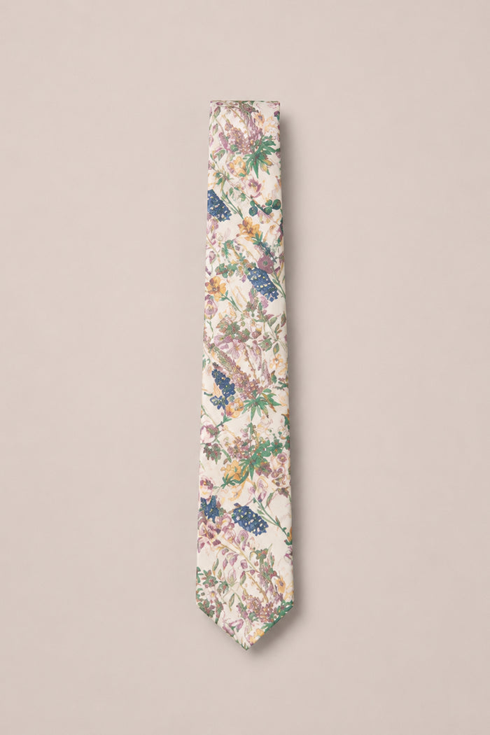 The Ties in Autumn Bouquet from Ivy City Co is a cream-colored necktie adorned with a floral pattern in shades of pink, purple, green, and blue on a light beige background—an ideal accessory for family photos or special gatherings.
