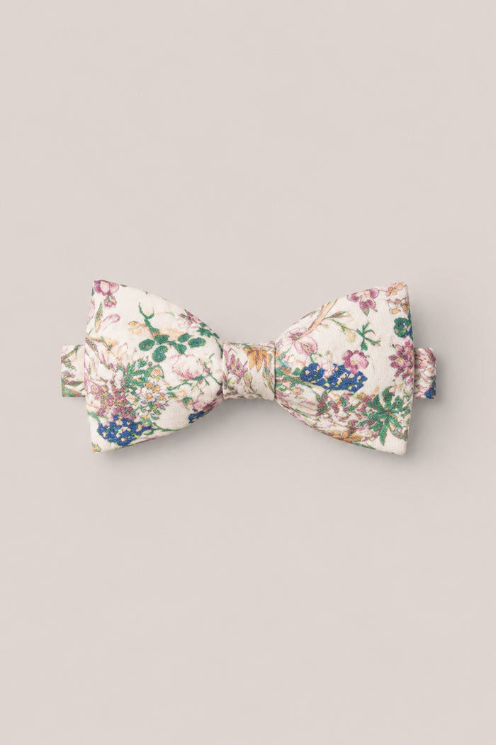 The Ties in Autumn Bouquet by Ivy City Co features a cream base adorned with an intricate floral pattern in shades of pink, purple, green, and blue—ideal for family photos or adding a refined accent to your outfit. Shown here on a simple light background.