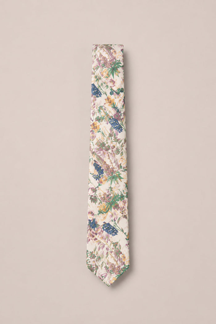 Add a touch of elegance to your wedding or family photo with the Ivy City Co Ties in Autumn Bouquet—a beige necktie featuring a detailed floral pattern in green, purple, pink, and blue, beautifully displayed against a plain light background.