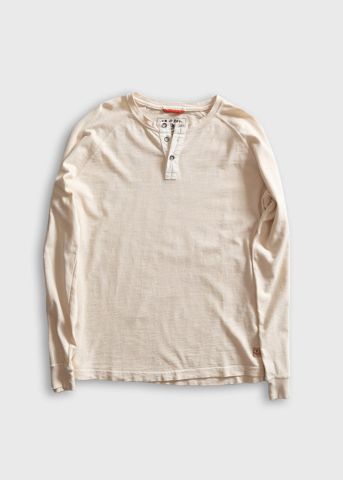 Cream long-sleeve henley shirt with buttoned placket, laid flat on a light background, showcasing casual style and texture.