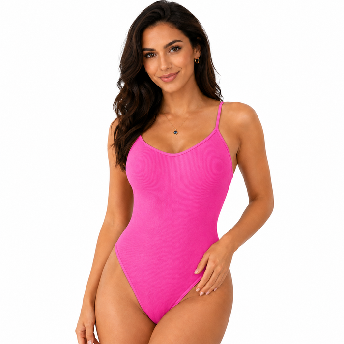 Pink women's shapewear bodysuit front view with ribbed texture, thin straps and fitted one-piece silhouette on white studio.