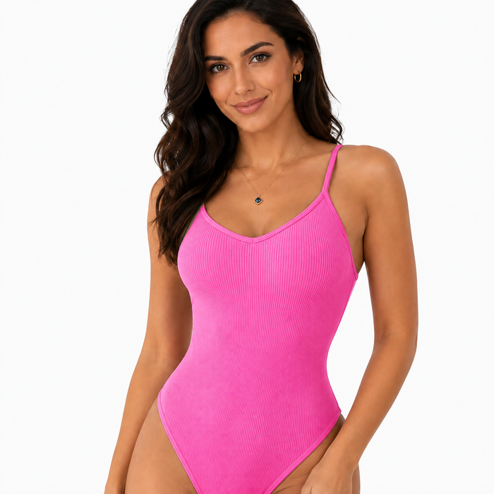 Pink women's bodysuit close-up showing ribbed fabric texture, scoop neckline and thin straps in a clean white studio setting.