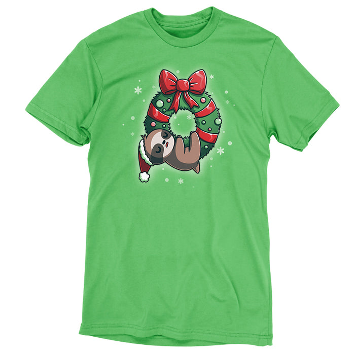 Premium Cotton T-shirt_TeeTurtle We Wish You a Lazy Christmas apple t-shirt featuring a cartoon sloth in a Santa hat, snoozing while hanging from a festive wreath adorned with red ribbons and ornaments.