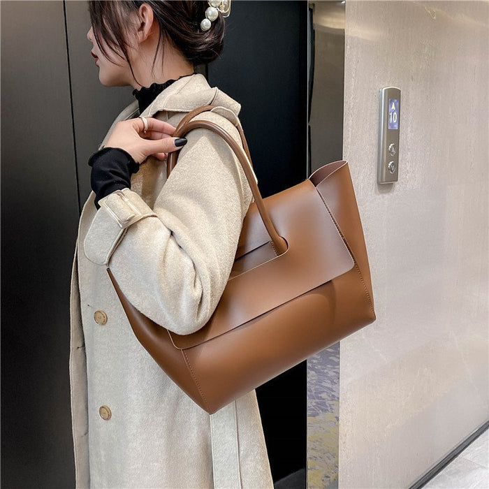women shoulder bag white minimalist tote with refined finish photographed under soft studio light
