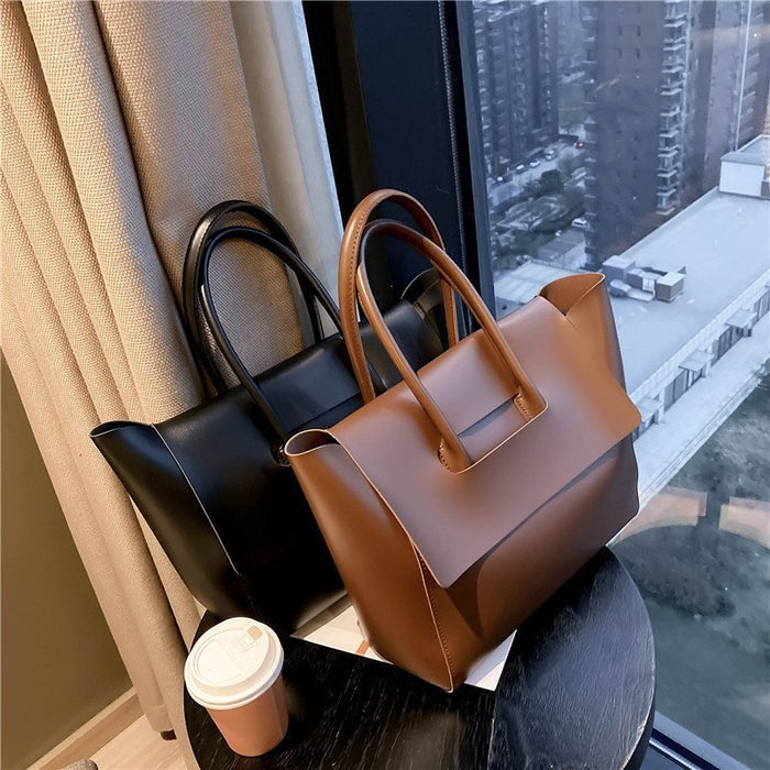 women shoulder bag styled with everyday essentials arranged neatly inside