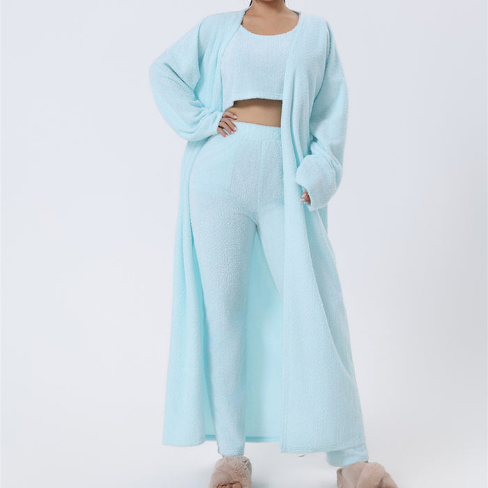Soft knit lounge set laid flat with cropped vest, matching pants and cardigan arranged for a clean catalog image.