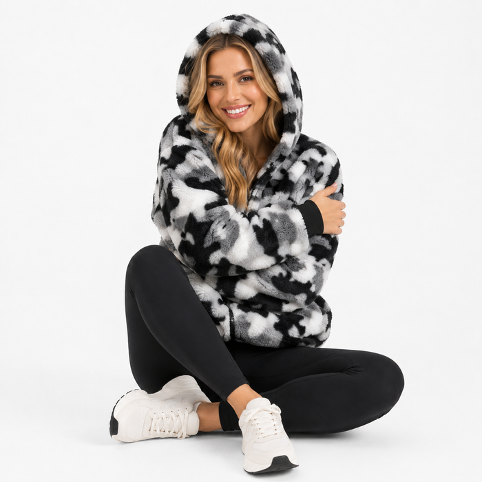 Pocketed camo hoodie for women shown as a soft zip-up layer for travel, lounging, errands and daily casual styling with ease.
