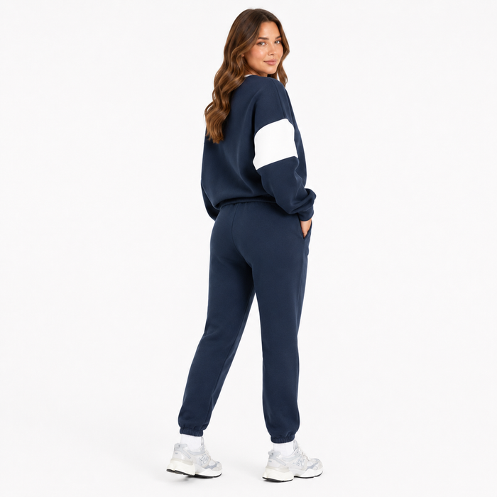 Women's navy drop shoulder sweatshirt set three quarter model view with white sleeve panels on white