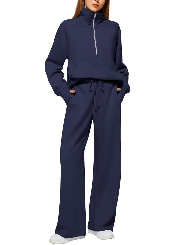 Sporty lounge set for women made from soft polyester with a half zip high neckline and easy wide leg trousers for daily wear.