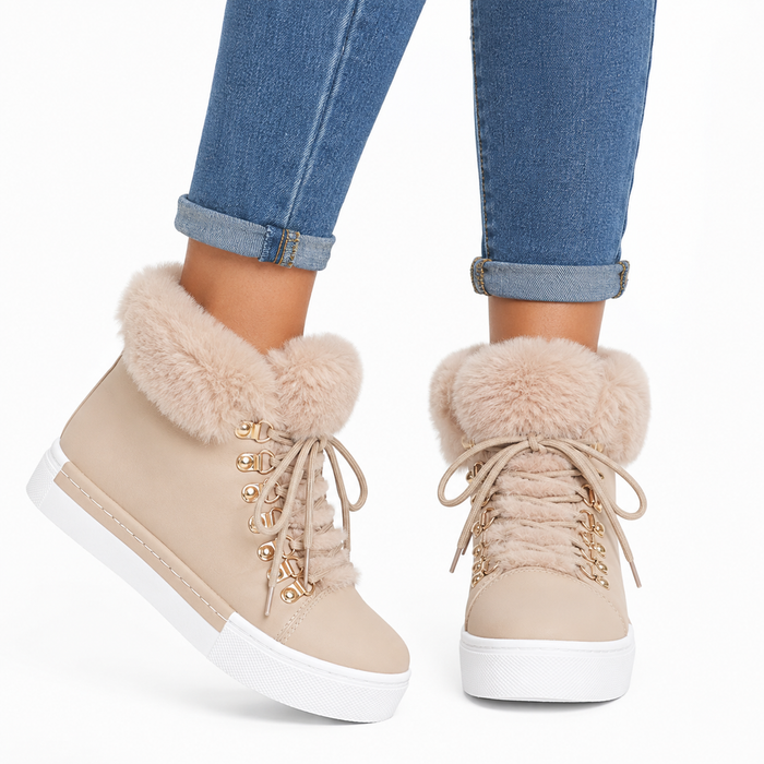 Close-up of women's beige lace-up ankle boots with fuzzy faux fur collar and gold-tone hardware