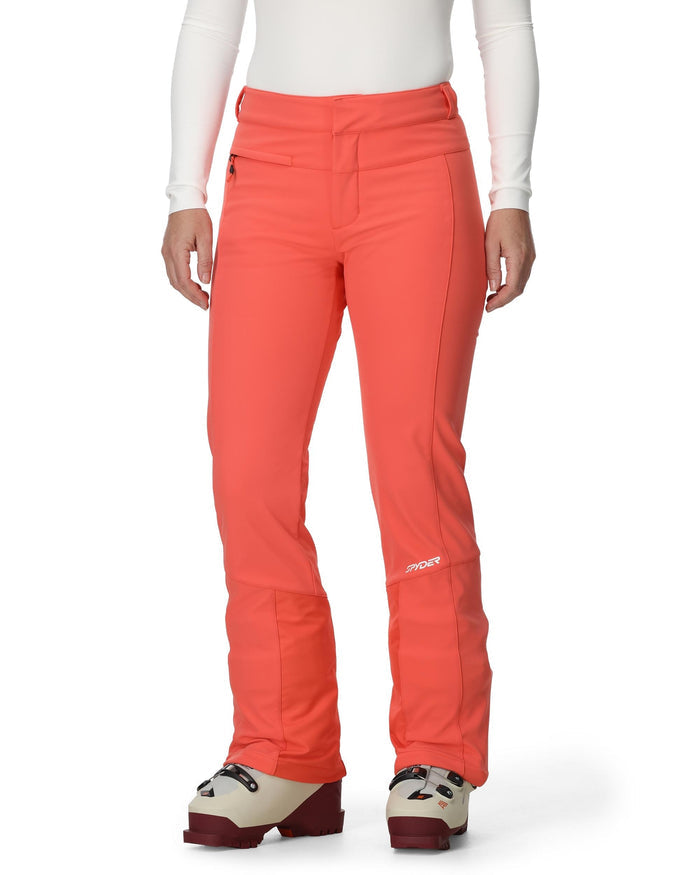 Person wearing bright orange ski pants with a white background