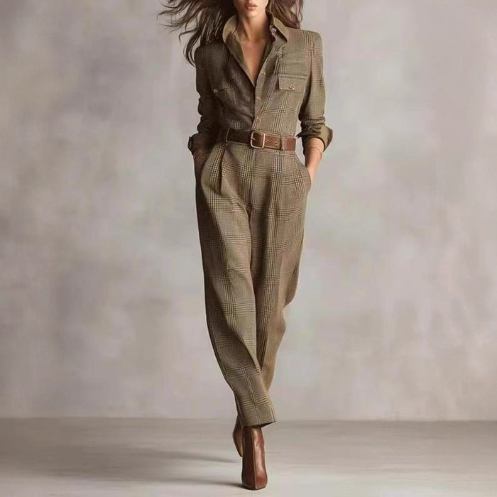 "detail of neckline and plaid pattern on women’s jumpsuit styled with minimal jewelry"