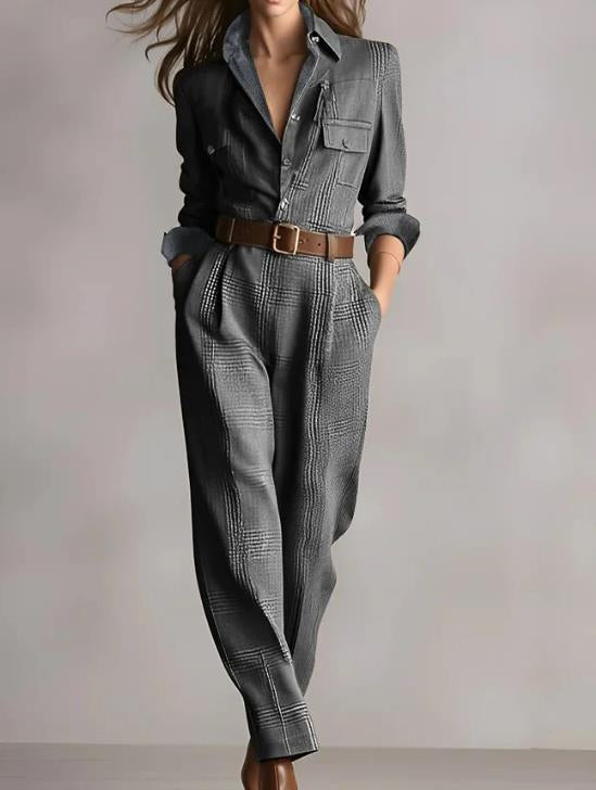 "detail of neckline and plaid pattern on women’s jumpsuit styled with minimal jewelry"