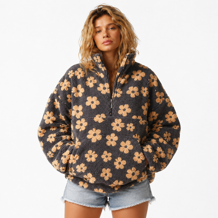 Women's sherpa pullover with floral print, half-zip collar, large front pocket, loose fit and plush polyester fleece texture.