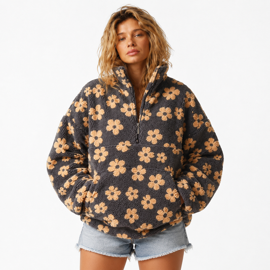 Women's sherpa pullover with floral print, half-zip collar, large front pocket, loose fit and plush polyester fleece texture.