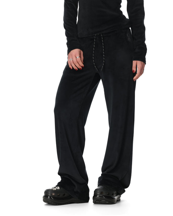 Person wearing black pants on a white background