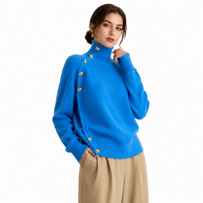 Women's sapphire blue turtleneck sweater shown on model with gold button detail against a white background
