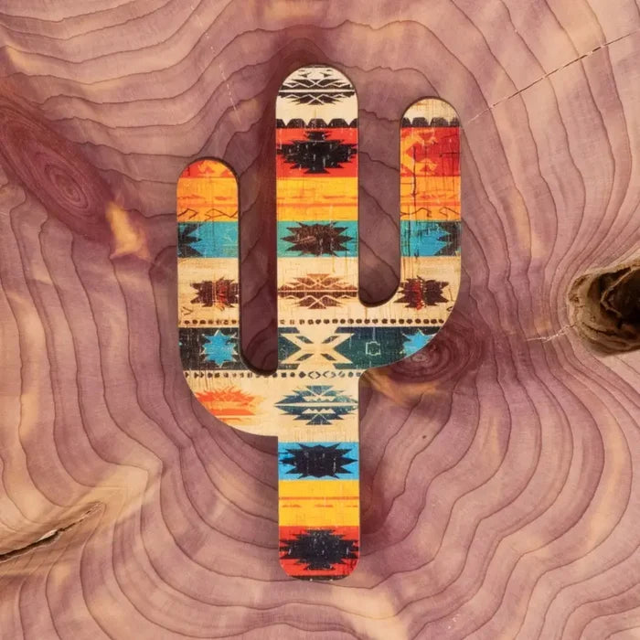 Wooden cactus magnet with bright Southwest geometric pattern on a rustic wood background.