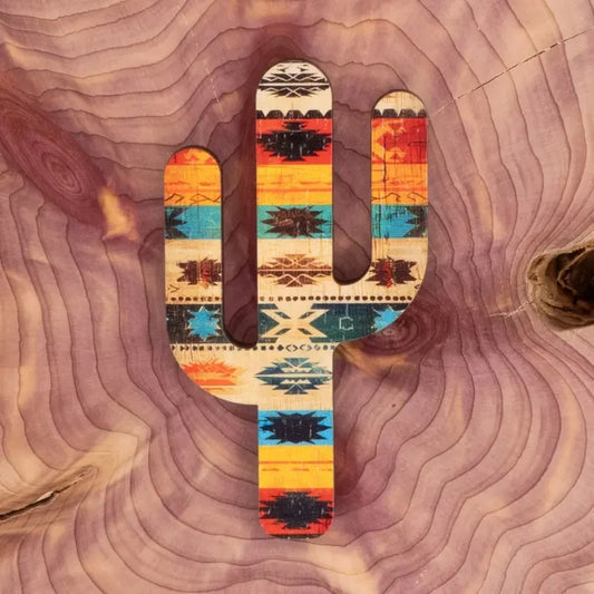 Wooden cactus magnet with bright Southwest geometric pattern on a rustic wood background.