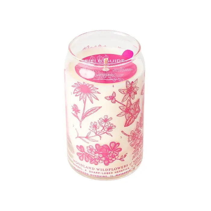 Woodland Wildflowers scented soy candle in a clear glass jar with pink floral illustrations.
