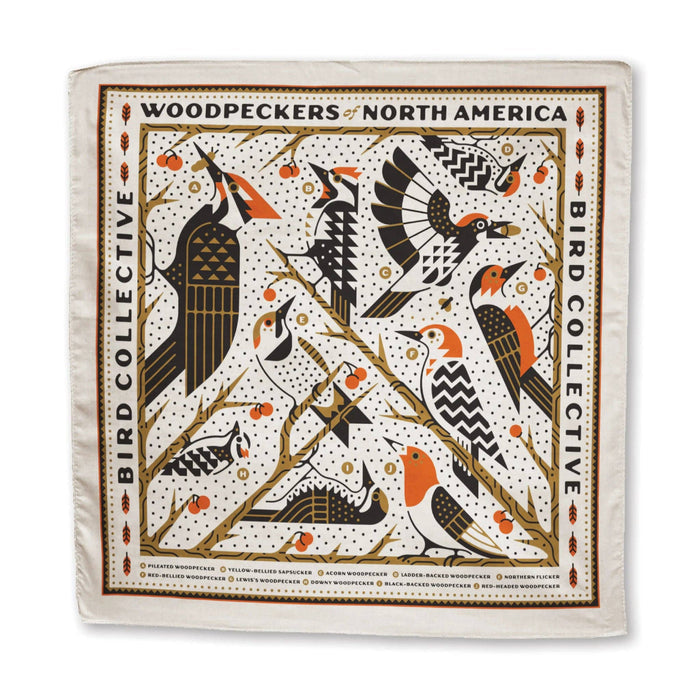 Woodpecker Bandana worn by a person outdoors, white fabric with orange and black woodpecker motifs