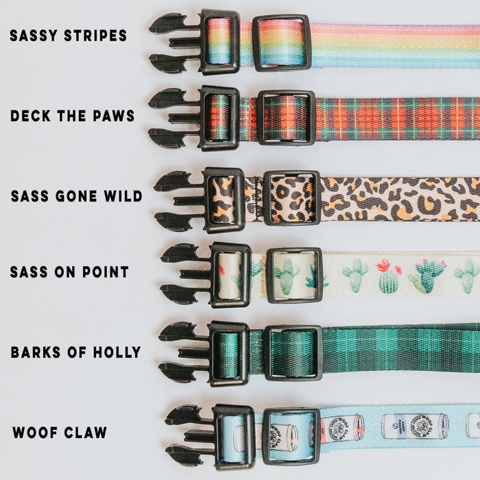 Six Sassy Woof collars in patterns like rainbow, holiday trees, leopard, cacti, holly, and sushi are displayed side by side—perfect for matching your Woof Pack Straps!.