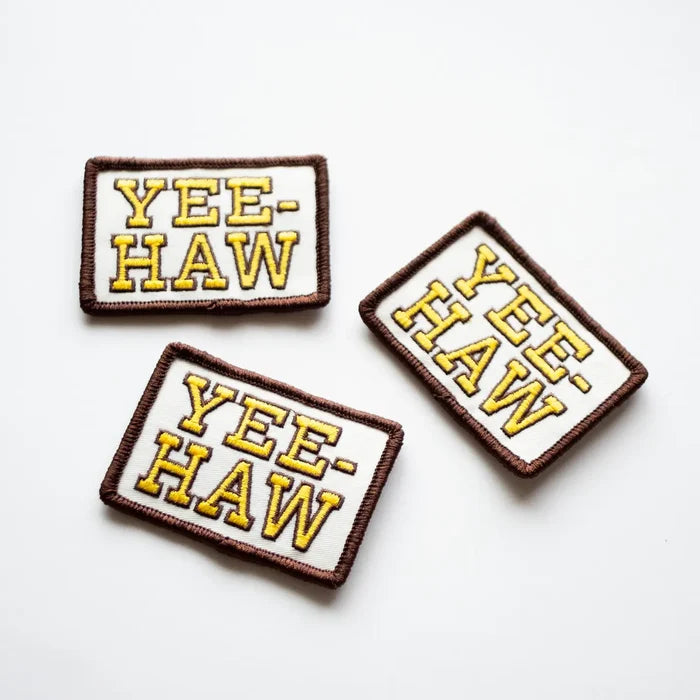 Three embroidered patches reading YEE HAW with yellow lettering and brown borders on white background